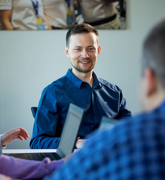 Working situation with three people and laptops